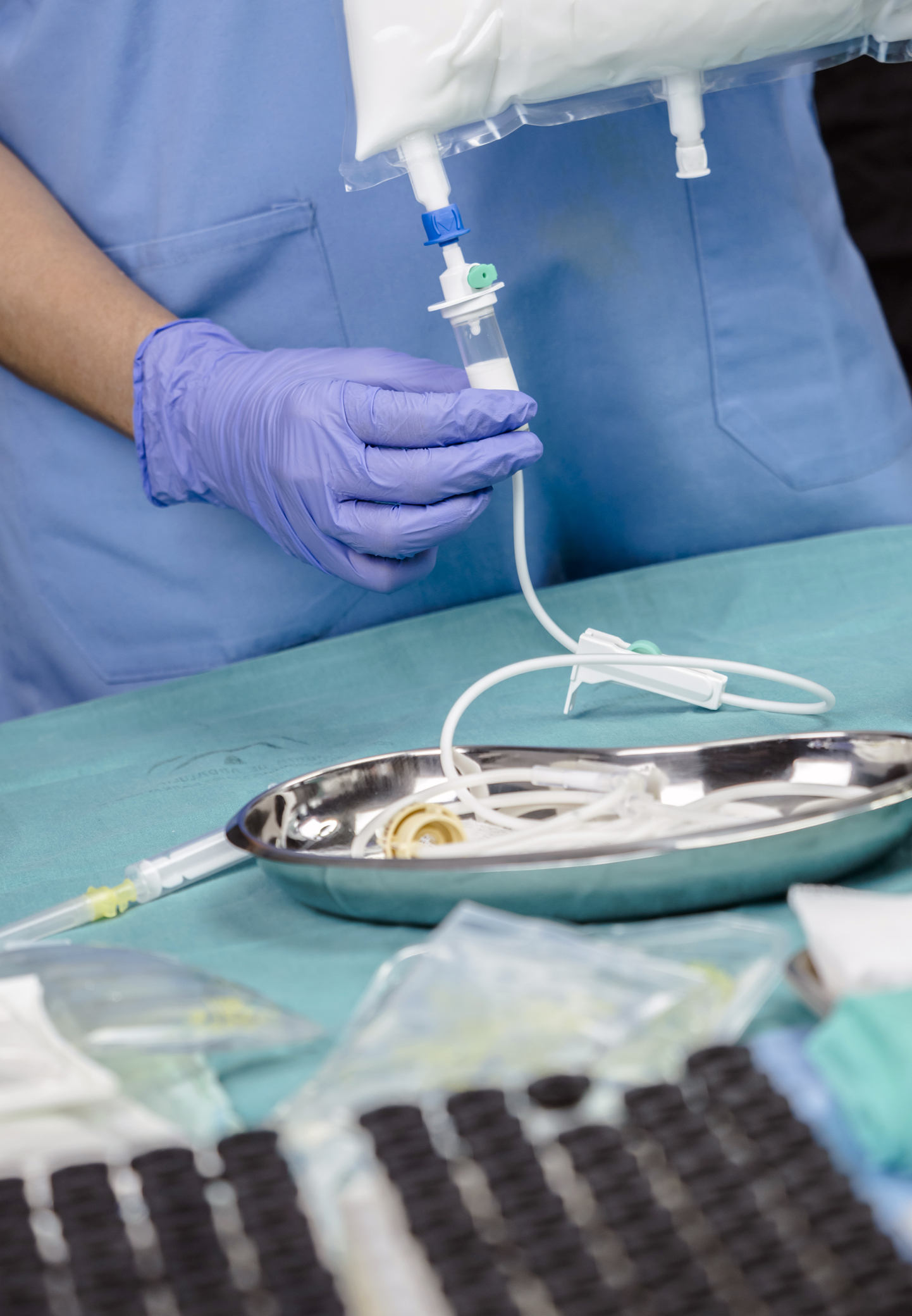 Nurse preparing medication for parenteral nutrition in a hospital for a MVID patient
